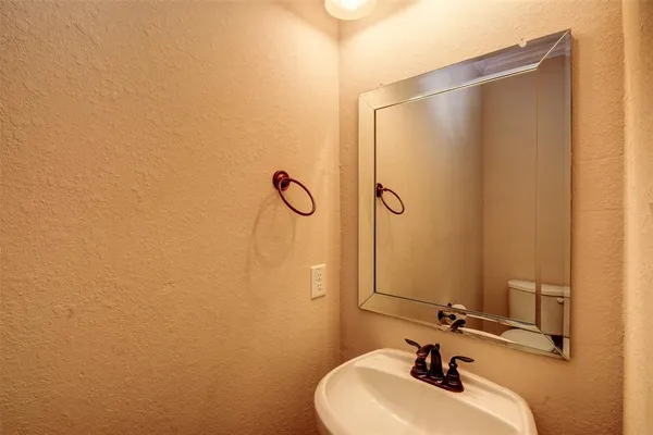 a bathroom with a sink a mirror and shower