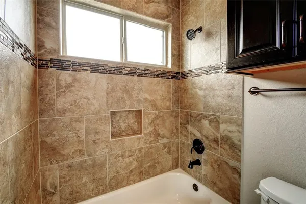 a bathroom with a bathtub and shower