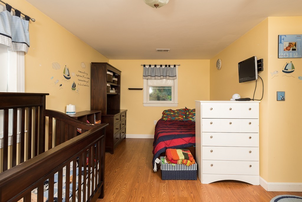 30 Wilder Road Norwell, MA 02061 - Photo 18 of 25 a bedroom with a bed and wooden floor