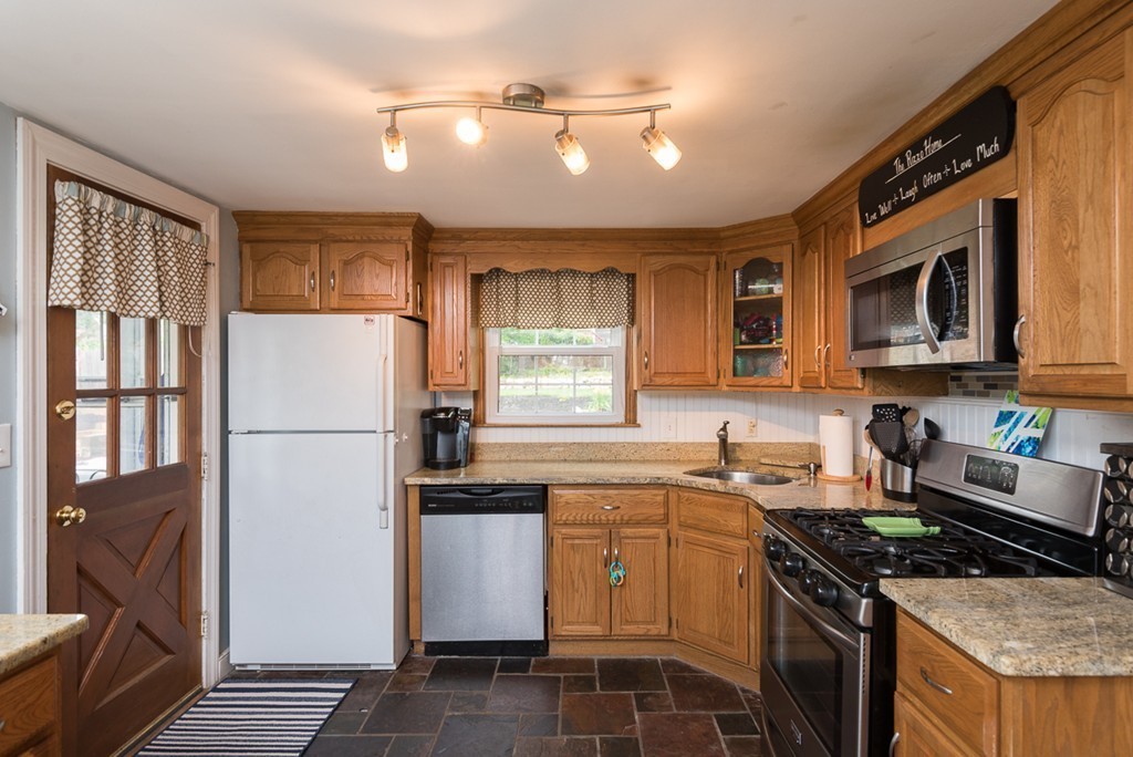 30 Wilder Road Norwell, MA 02061 - Photo 5 of 25 a kitchen with granite countertop a refrigerator stove top oven and sink