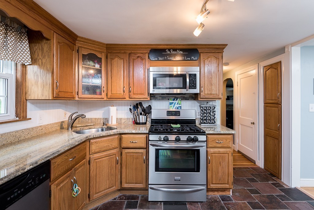 30 Wilder Road Norwell, MA 02061 - Photo 6 of 25 a kitchen with stainless steel appliances granite countertop a stove a sink and a microwave