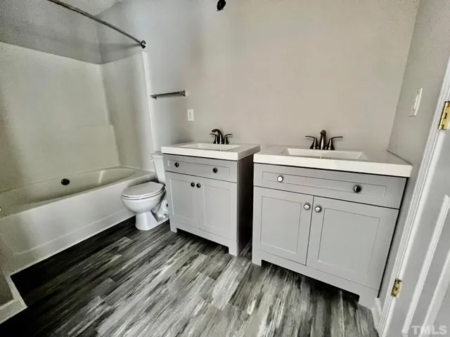 a bathroom with a sink toilet a shower and vanity