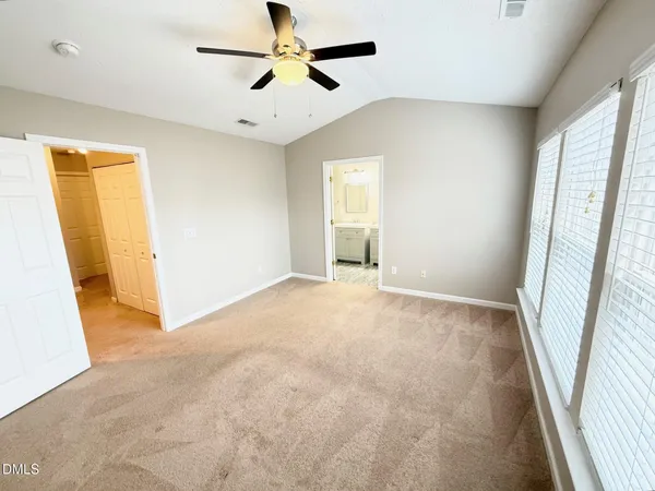 an empty room with windows and entrance