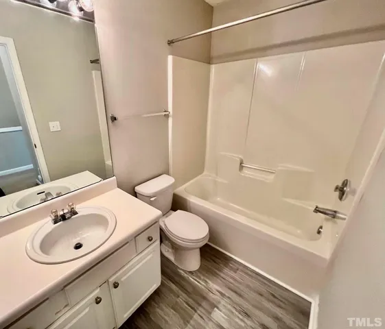 a bathroom with a sink toilet a mirror and shower