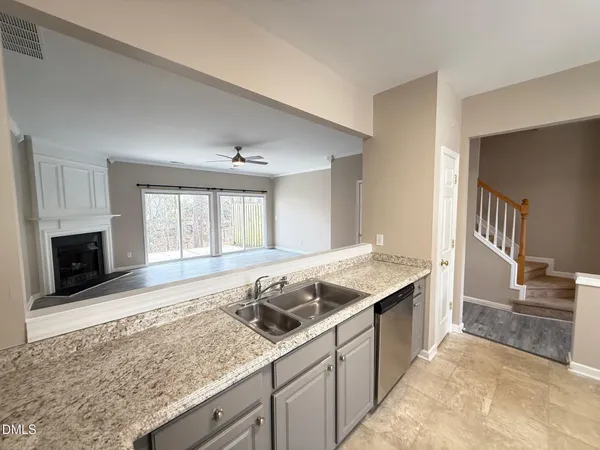 a kitchen with stainless steel appliances granite countertop a sink stove and cabinets