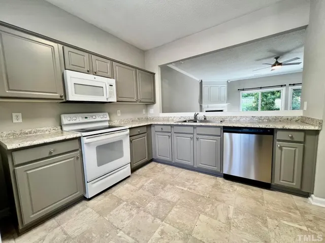 a kitchen with stainless steel appliances granite countertop a sink and stove top oven