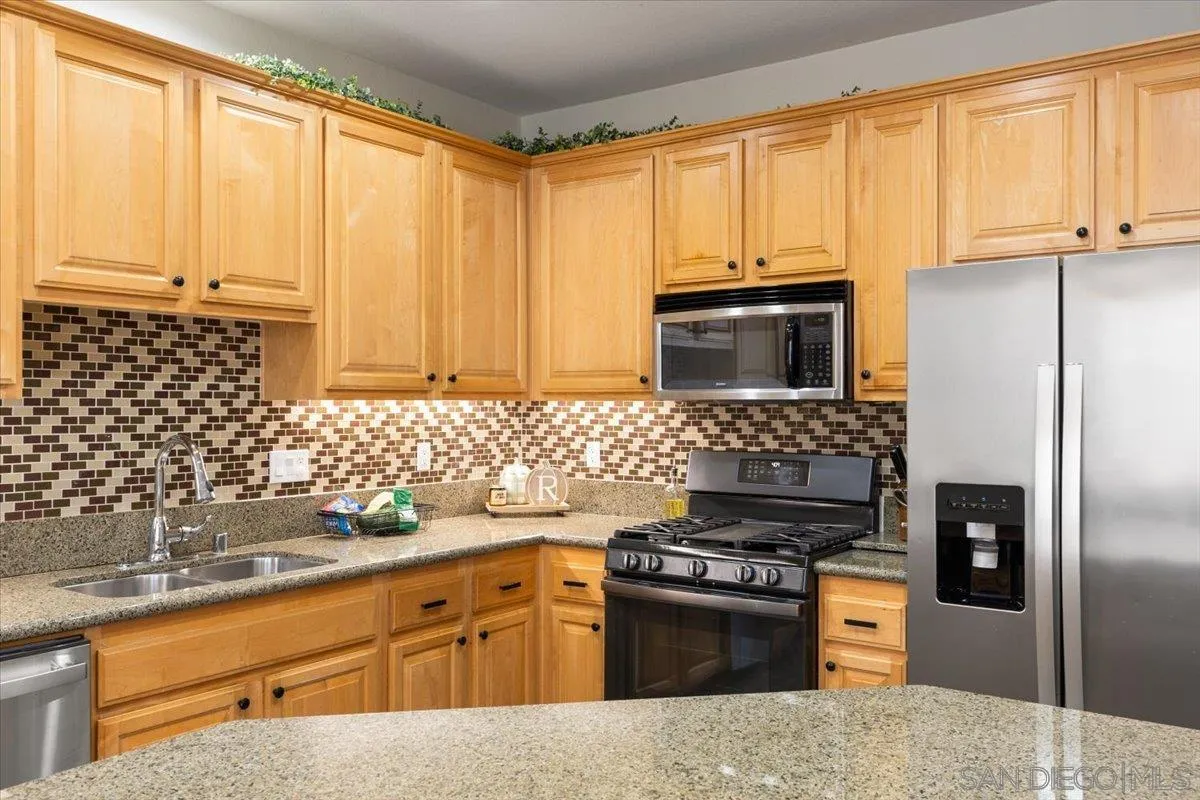 a kitchen with stainless steel appliances a stove sink and microwave