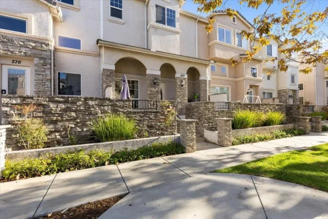 a front view of a residential houses with yard