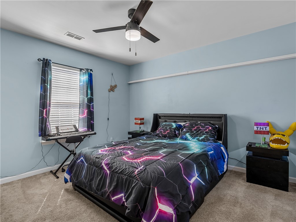 2520 Linmar Circle Anderson, SC 29621 - Photo 28 of 50 A well-lit bedroom features plush carpeting and a modern ceiling fan, creating a comfortable retreat.