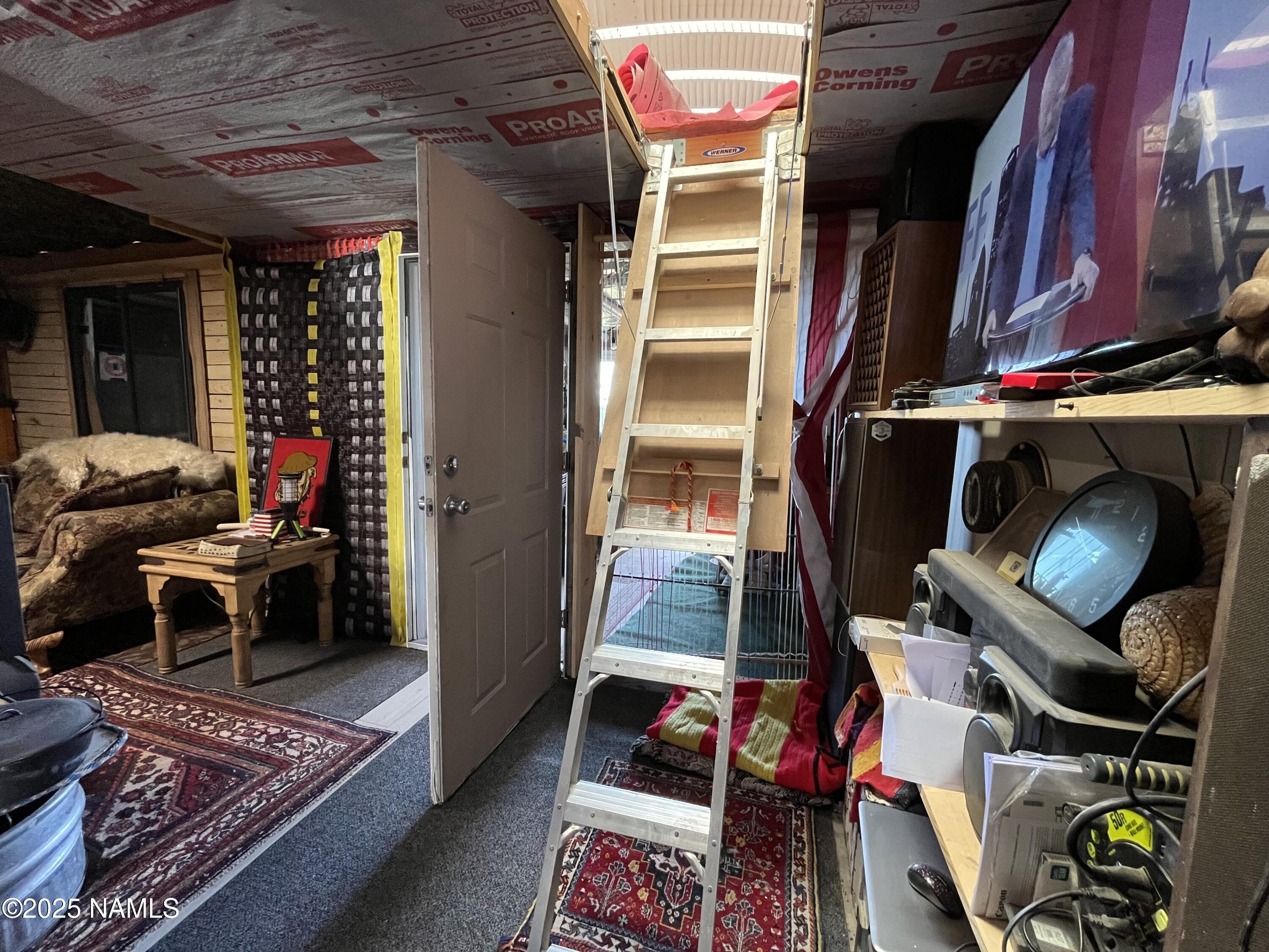 613 East Mountain Cat Road Williams, AZ 86046 - Photo 11 of 29 a living room with furniture a rug and a fireplace