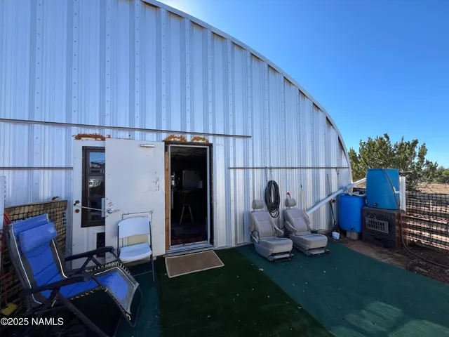 a view of a porch with seating space and backyard