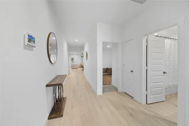 a view of a room with wooden floor and white walls