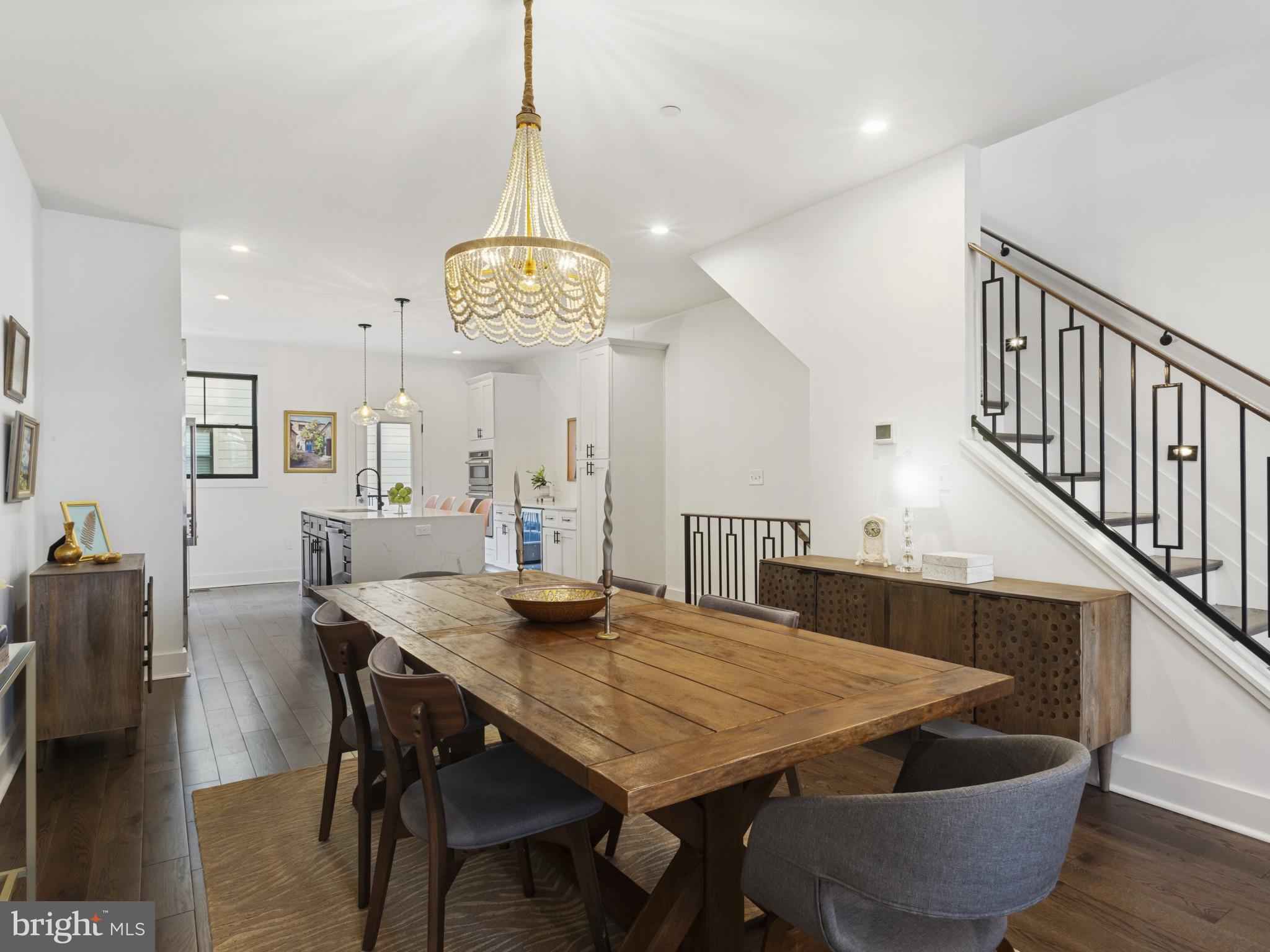 1404 Olive Street Baltimore, MD 21230 - Photo 13 of 38 a view of a dining room and livingroom with furniture wooden floor a chandelier