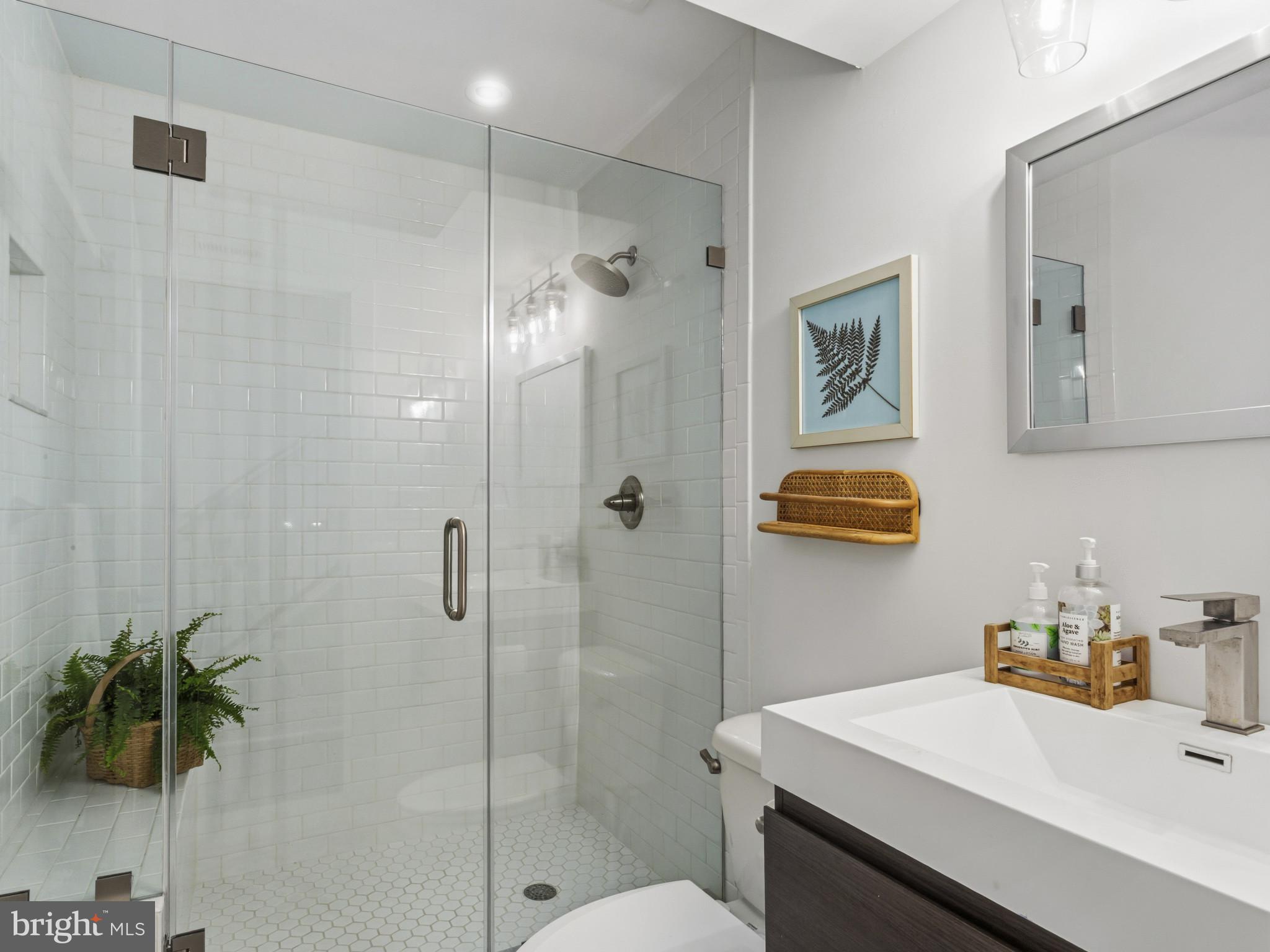 1404 Olive Street Baltimore, MD 21230 - Photo 15 of 38 a bathroom with a sink a toilet and shower