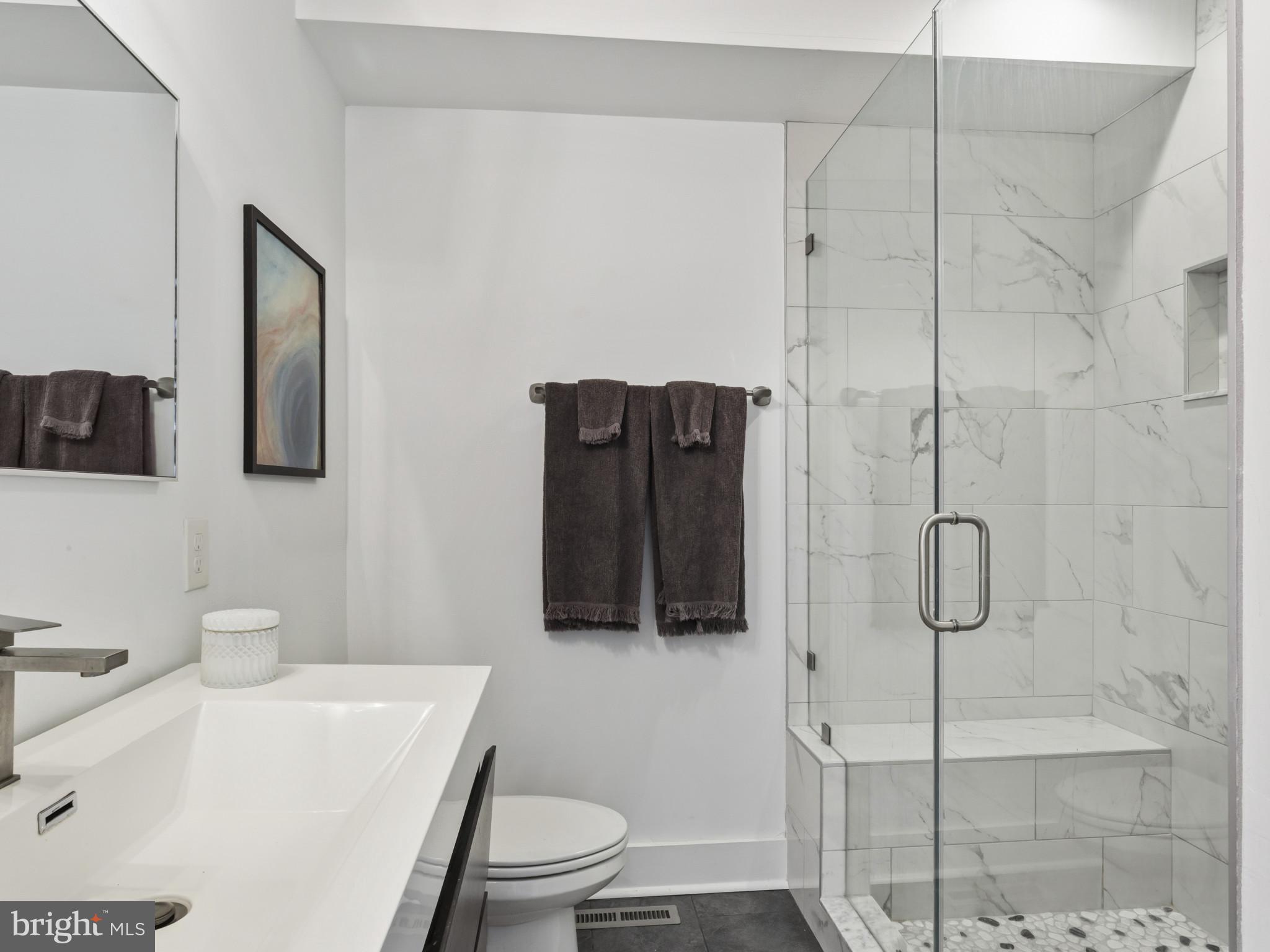 1404 Olive Street Baltimore, MD 21230 - Photo 25 of 38 a bathroom with a toilet a sink and shower