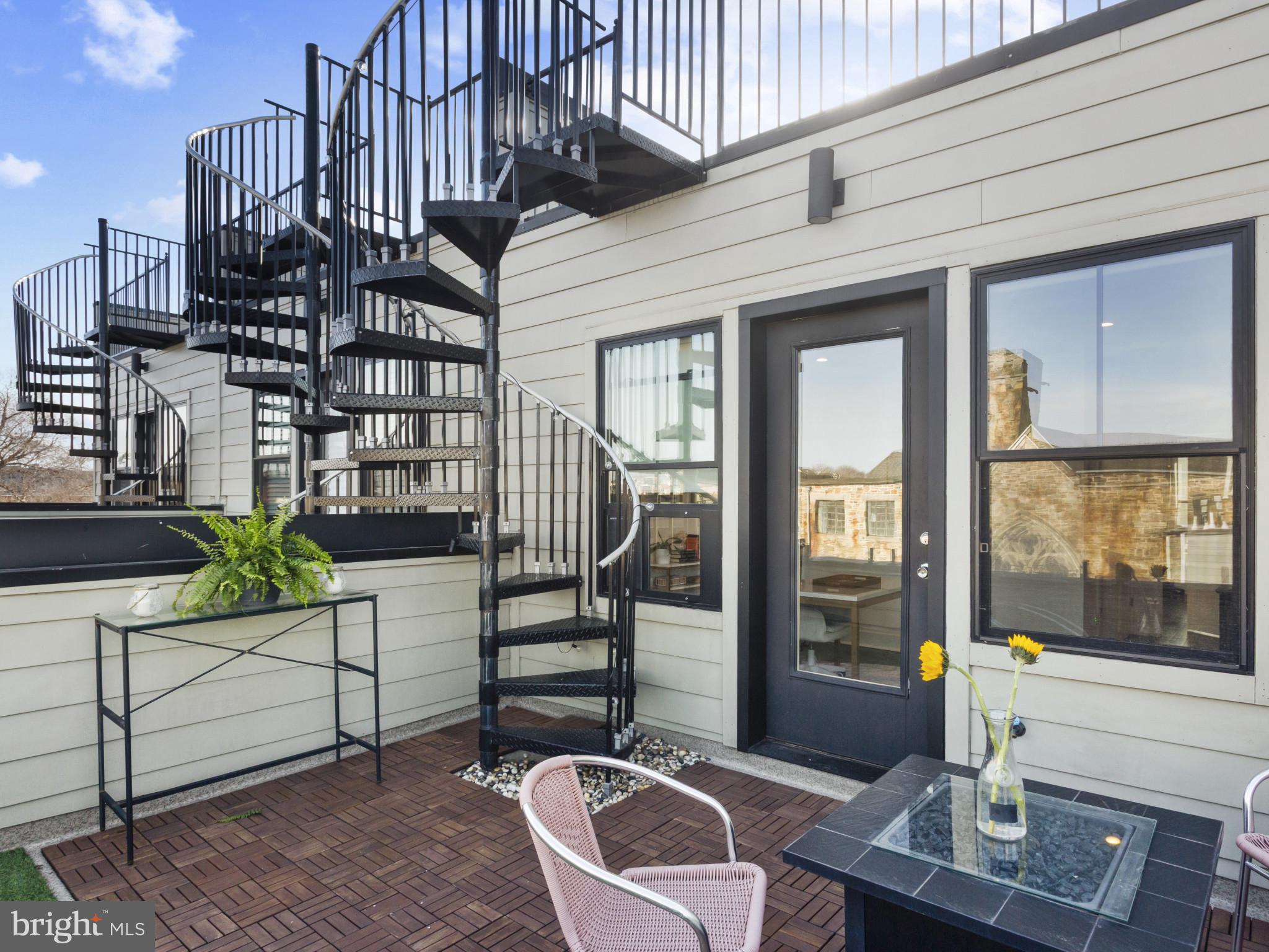 1404 Olive Street Baltimore, MD 21230 - Photo 32 of 38 a balcony with chairs and a potted plant