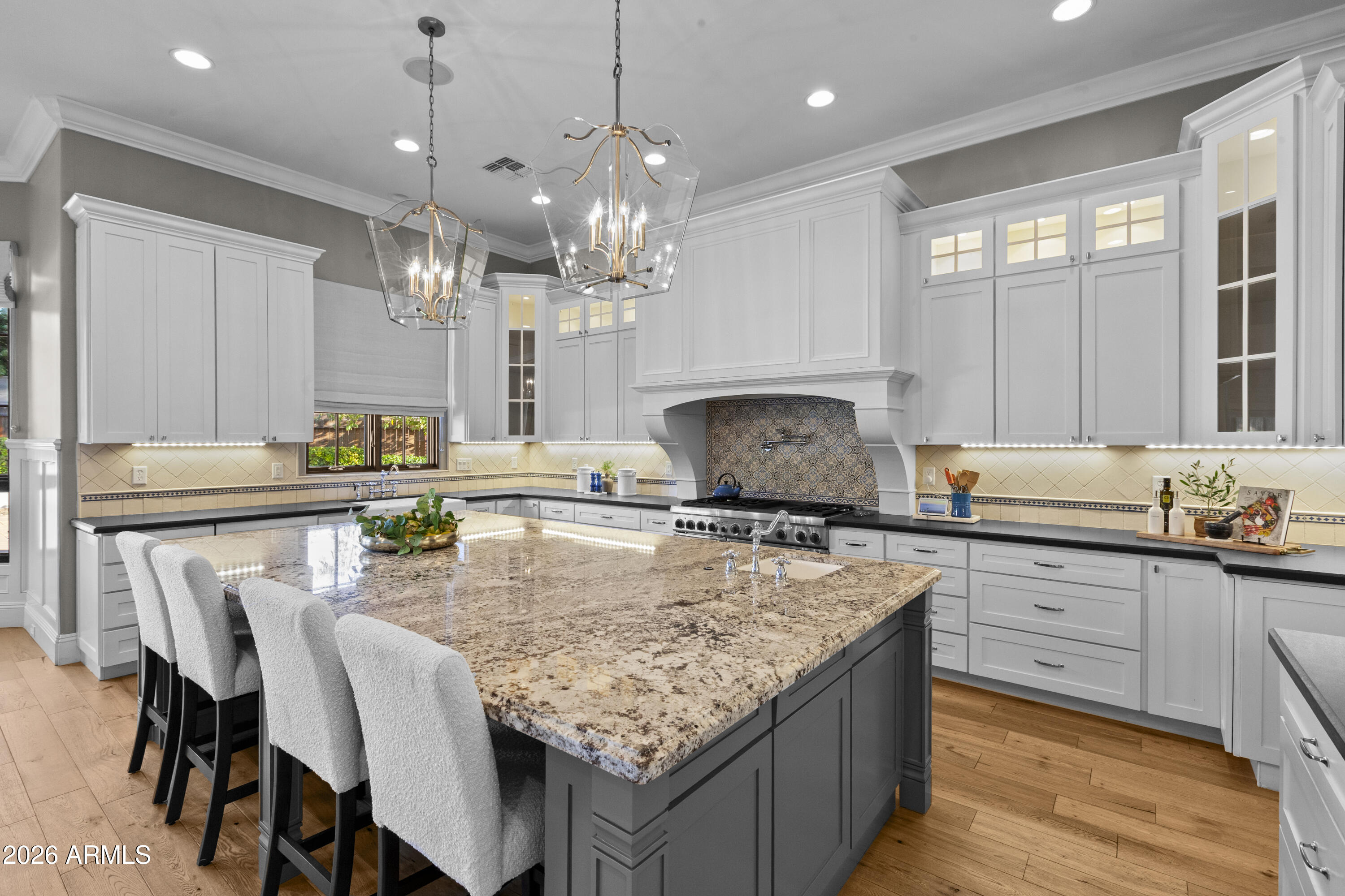 4909 North 45th Place Phoenix, AZ 85018 - Photo 11 of 45 a kitchen with kitchen island granite countertop a center island a stove cabinets a dining table and chairs