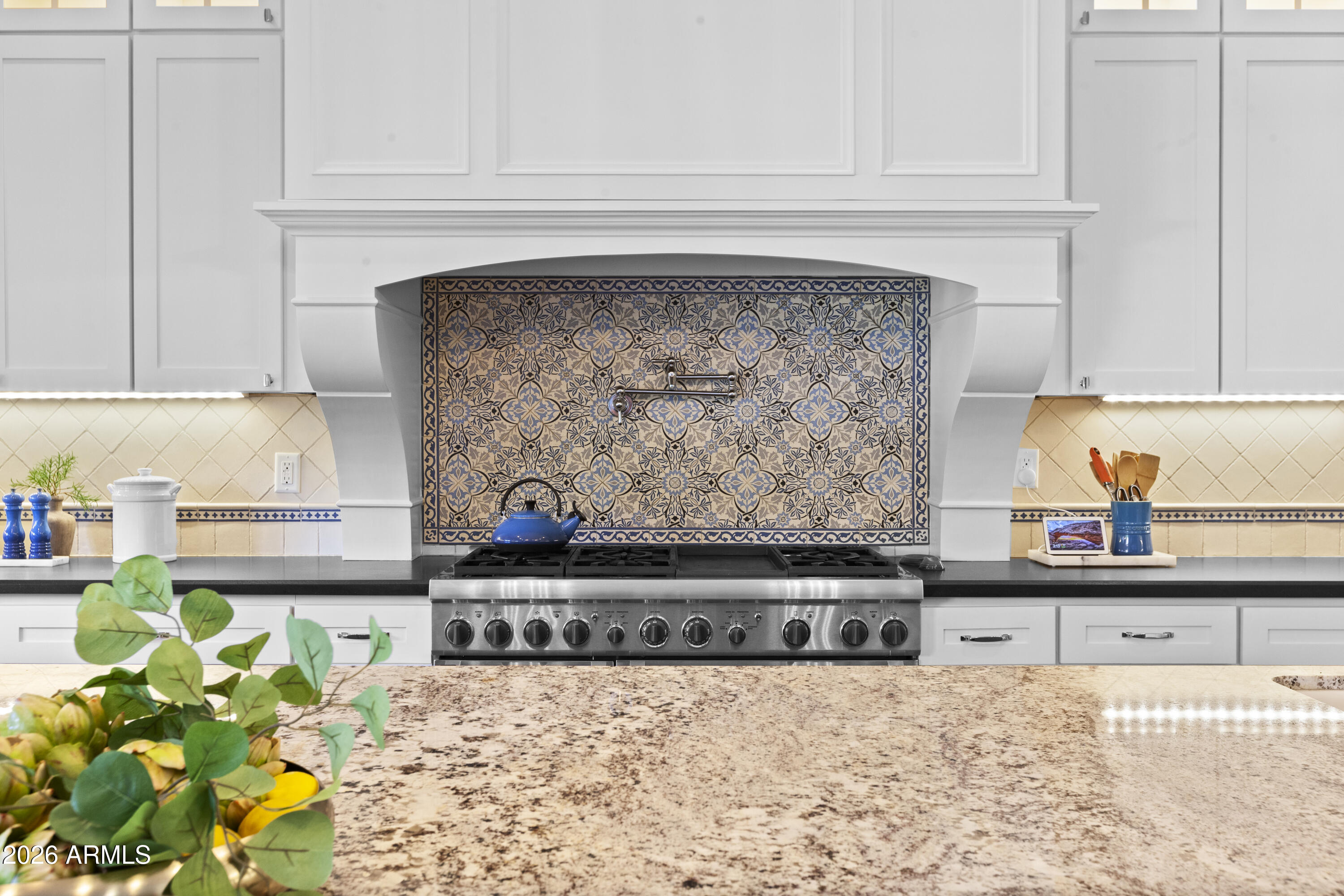 4909 North 45th Place Phoenix, AZ 85018 - Photo 12 of 45 a kitchen with a stove top oven and a counter top space