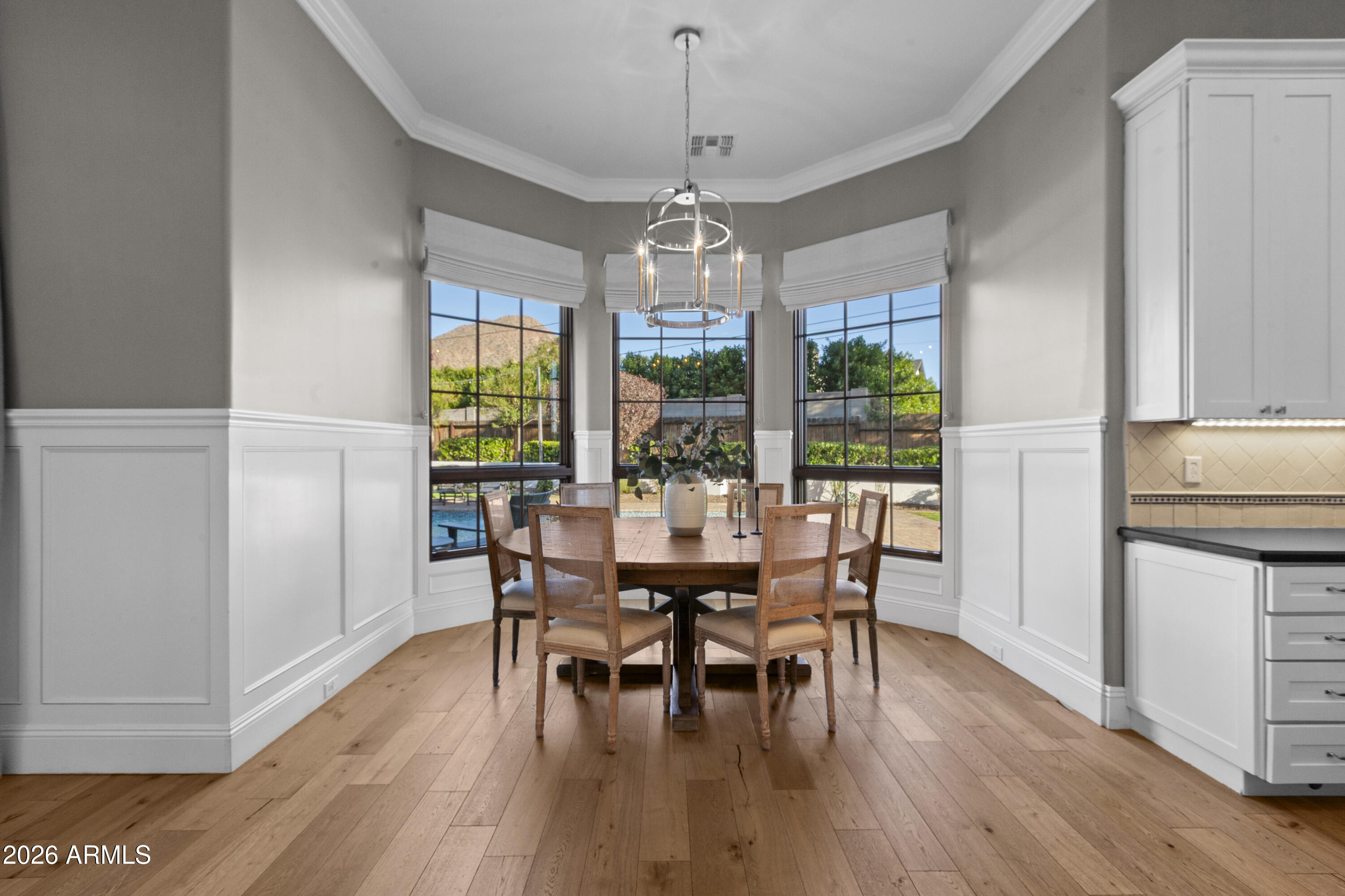 4909 North 45th Place Phoenix, AZ 85018 - Photo 17 of 45 a dining room with furniture window wooden floor