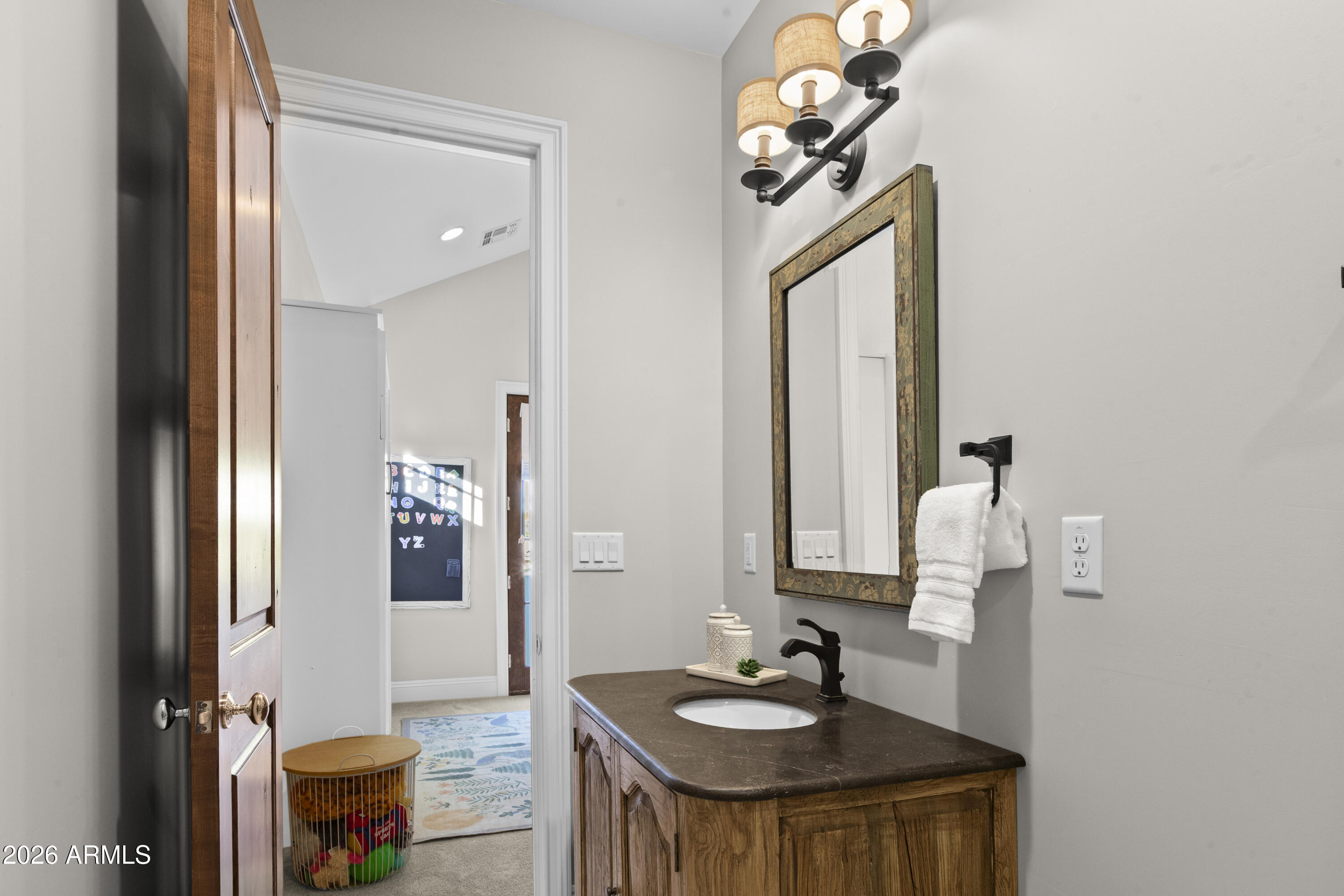4909 North 45th Place Phoenix, AZ 85018 - Photo 41 of 45 a bathroom with a sink and a mirror