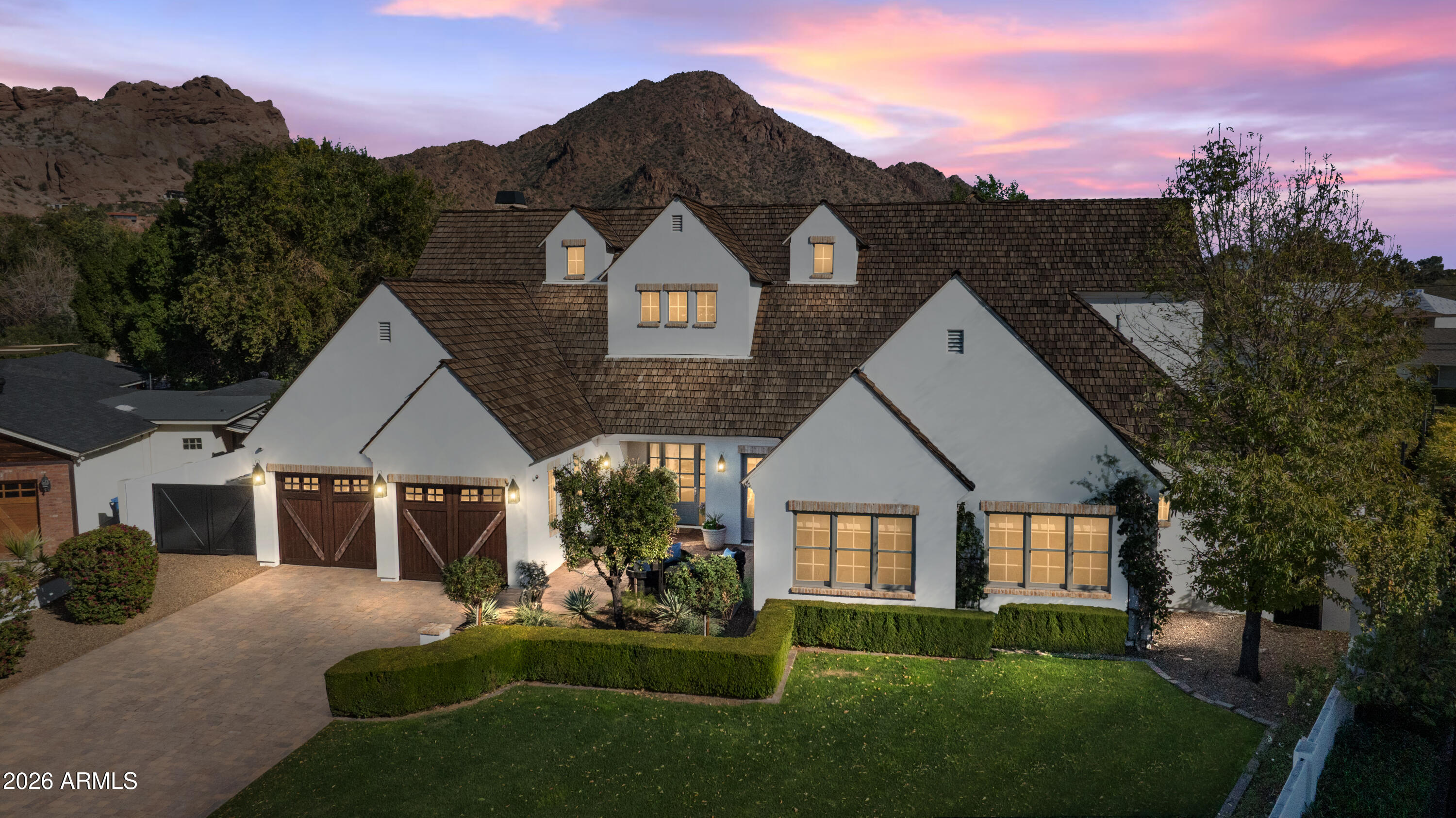 4909 North 45th Place Phoenix, AZ 85018 - Photo 45 of 45 a front view of a house with a yard and garage