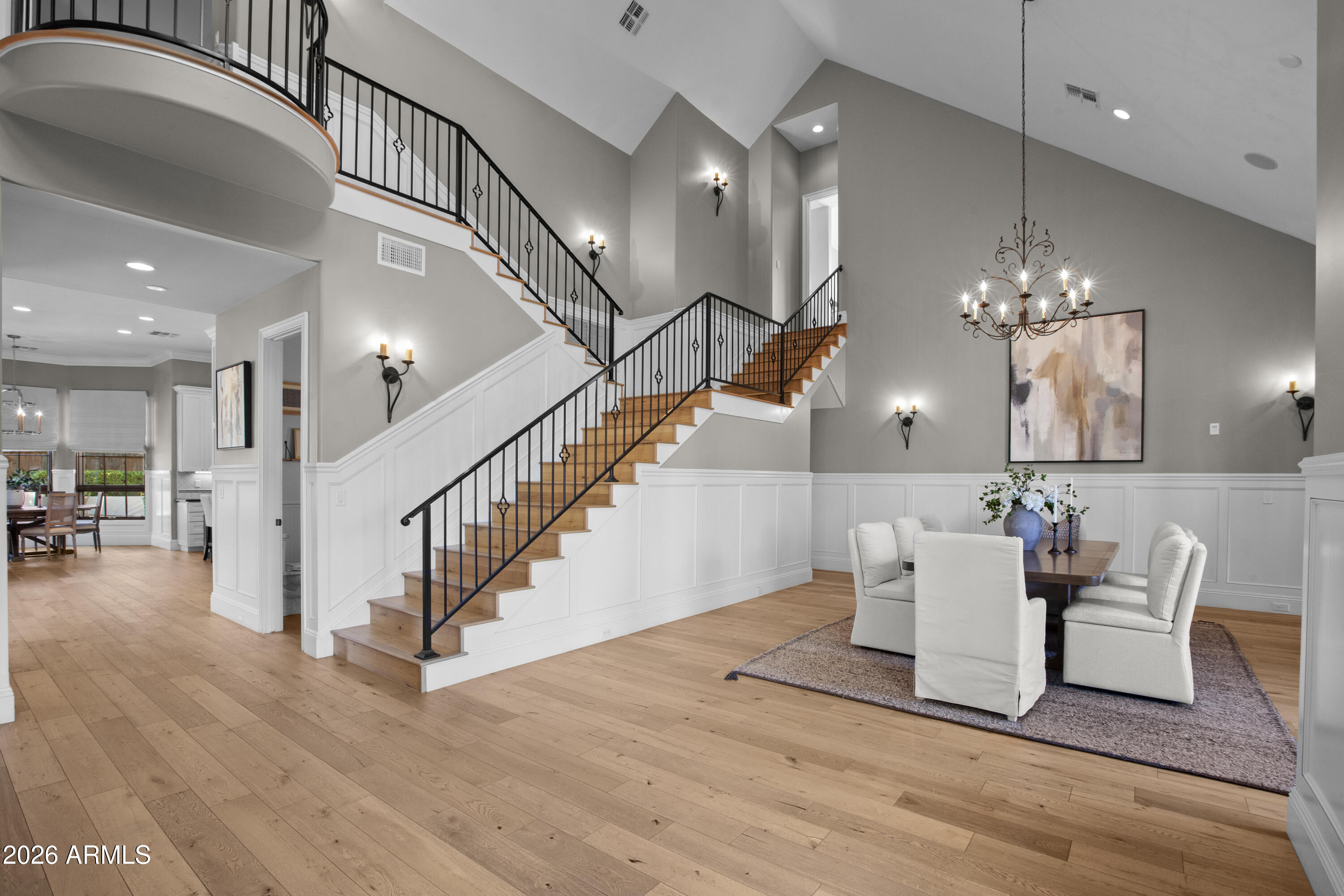 4909 North 45th Place Phoenix, AZ 85018 - Photo 7 of 45 a dining room with wooden floor a chandelier a glass table and chairs