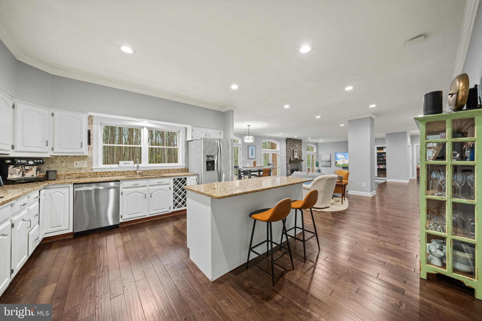 642 Springvale Road Great Falls, VA 22066 - Photo 11 of 50 a kitchen with stainless steel appliances kitchen island granite countertop a table chairs stove and cabinets