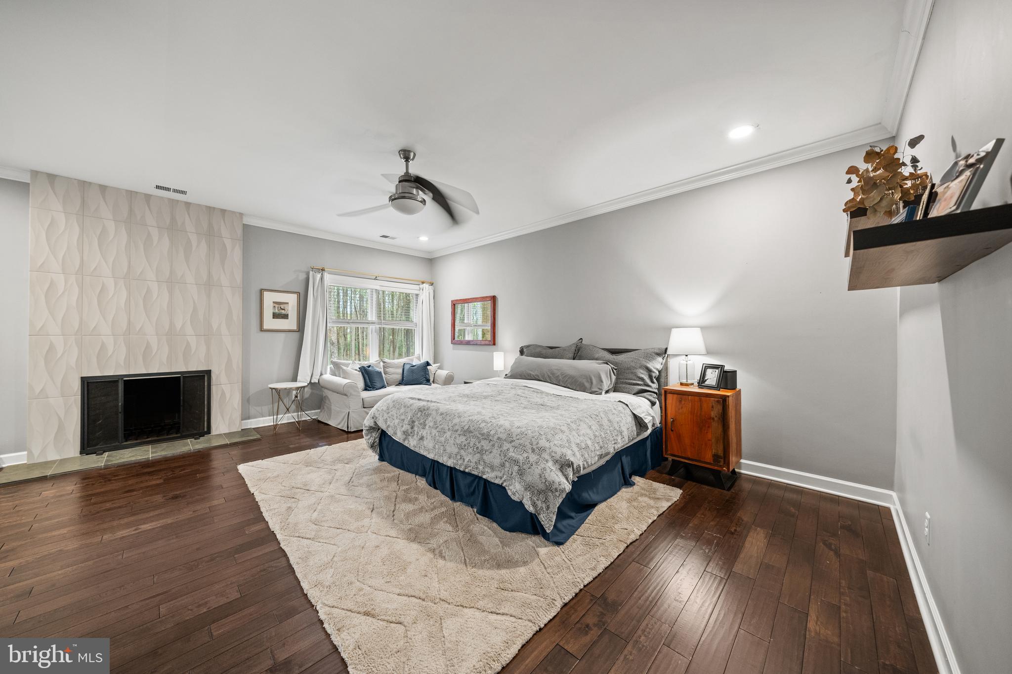 642 Springvale Road Great Falls, VA 22066 - Photo 24 of 50 a spacious bedroom with a bed and a fireplace