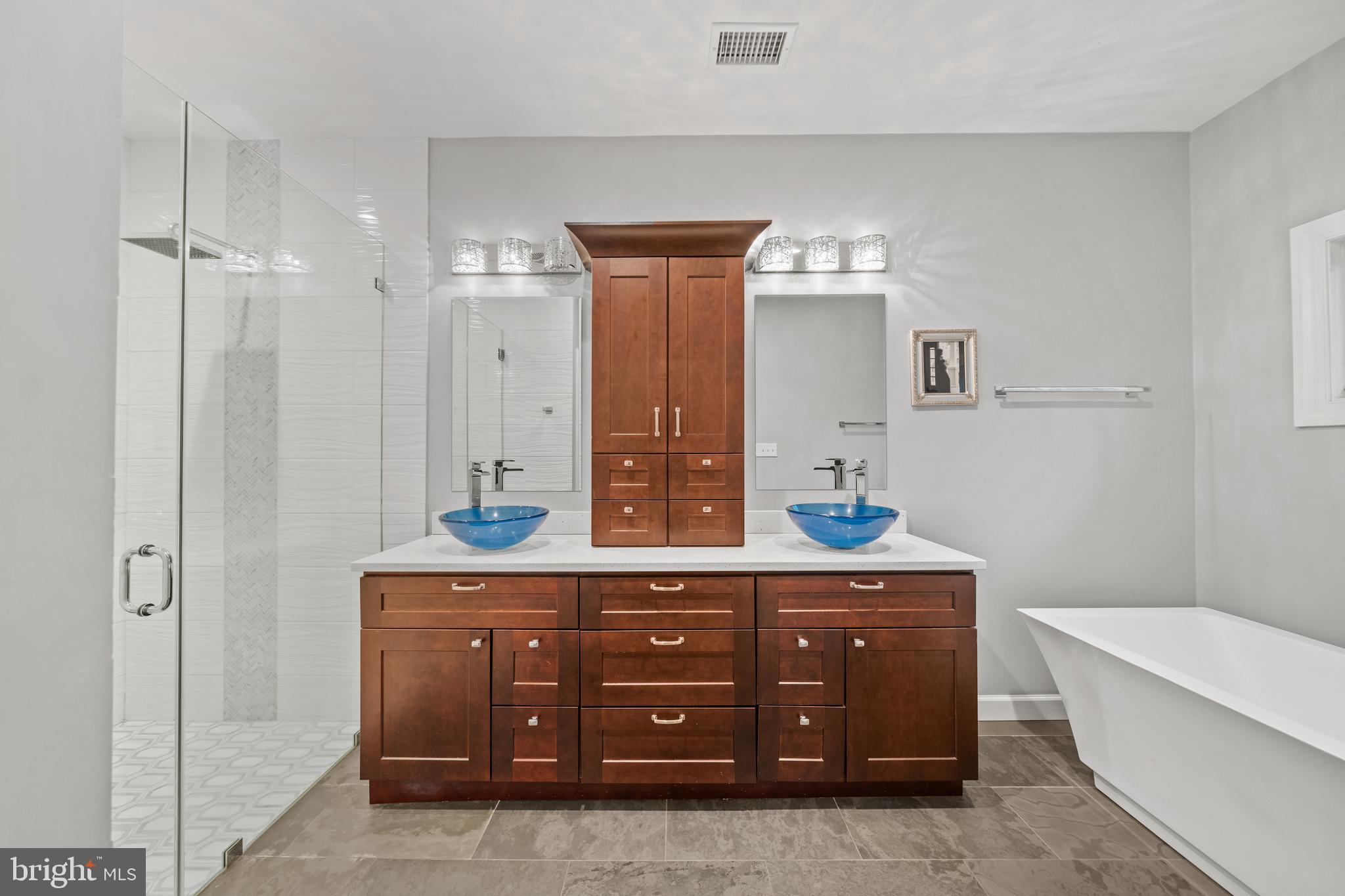 642 Springvale Road Great Falls, VA 22066 - Photo 28 of 50 a spacious bathroom with a granite countertop sink a toilet and a tub