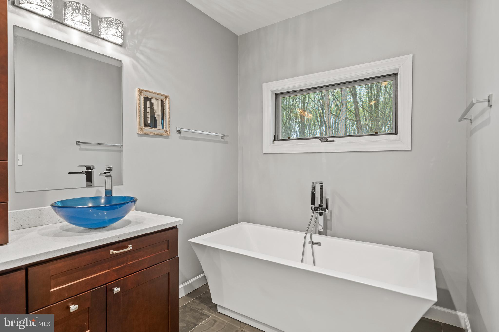 642 Springvale Road Great Falls, VA 22066 - Photo 29 of 50 a bathroom with a sink a window and a mirror