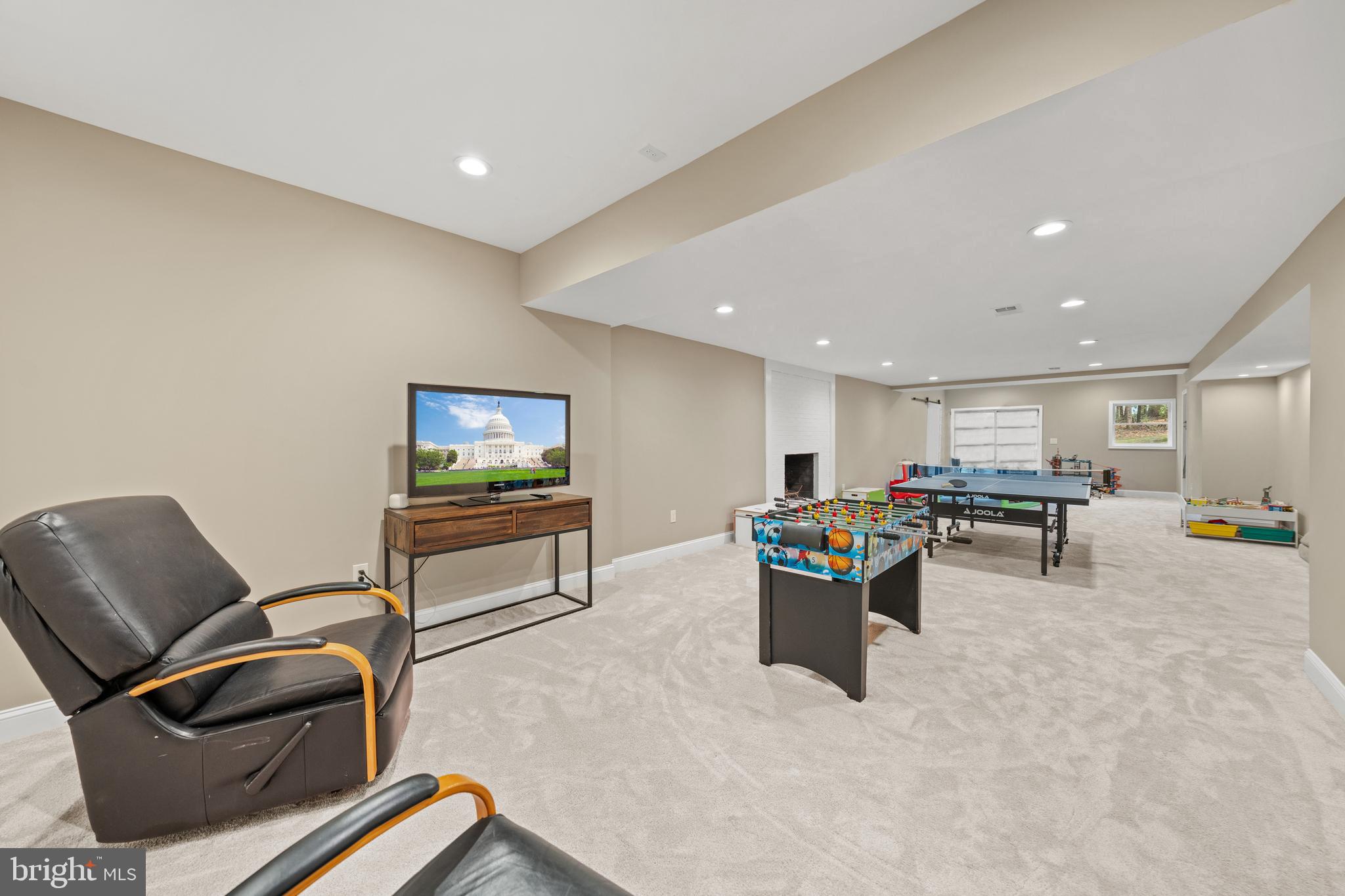 642 Springvale Road Great Falls, VA 22066 - Photo 37 of 50 a living room with furniture and a flat screen tv