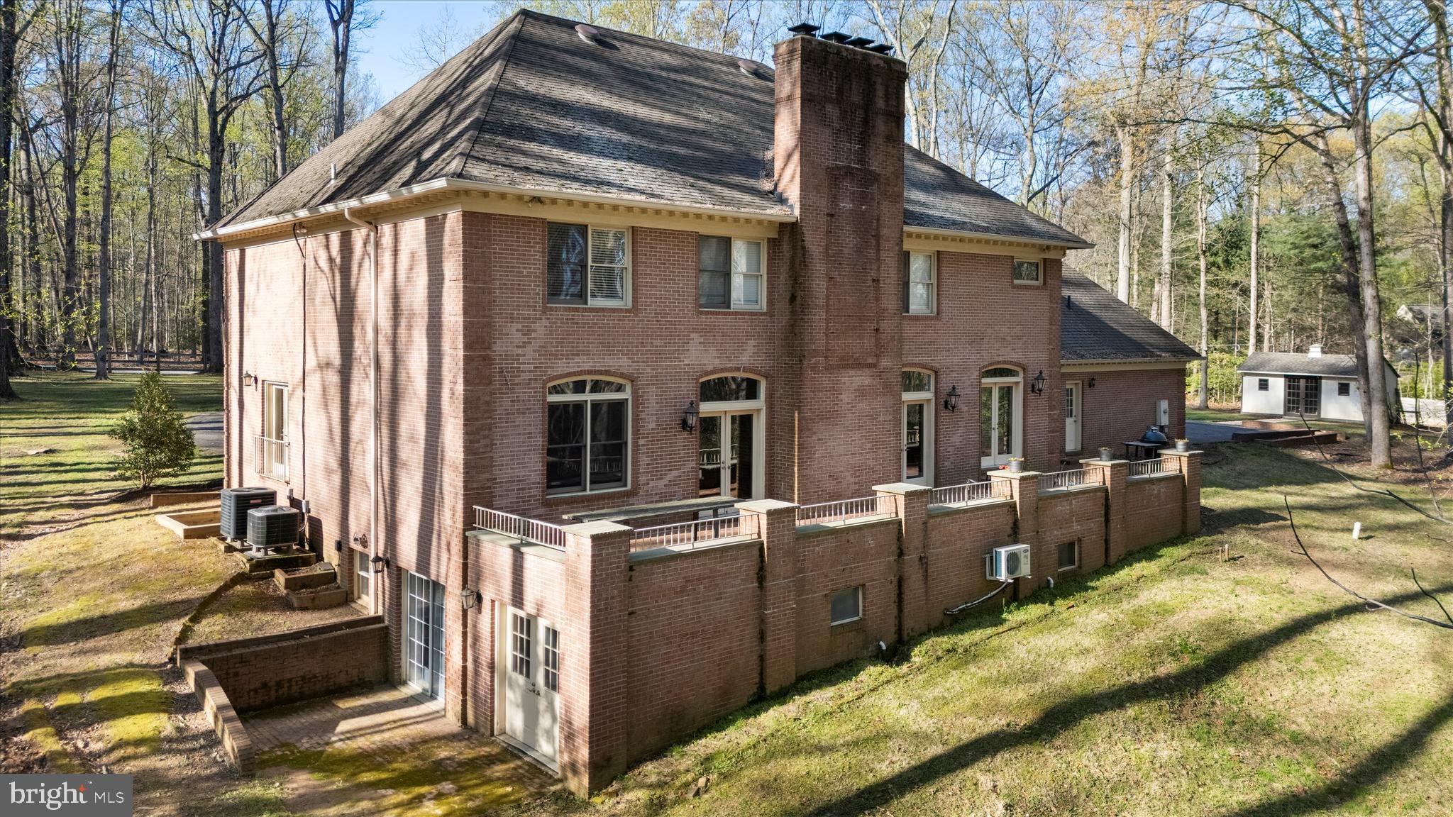 642 Springvale Road Great Falls, VA 22066 - Photo 43 of 50 a backyard of a house with barbeque oven and outdoor seating