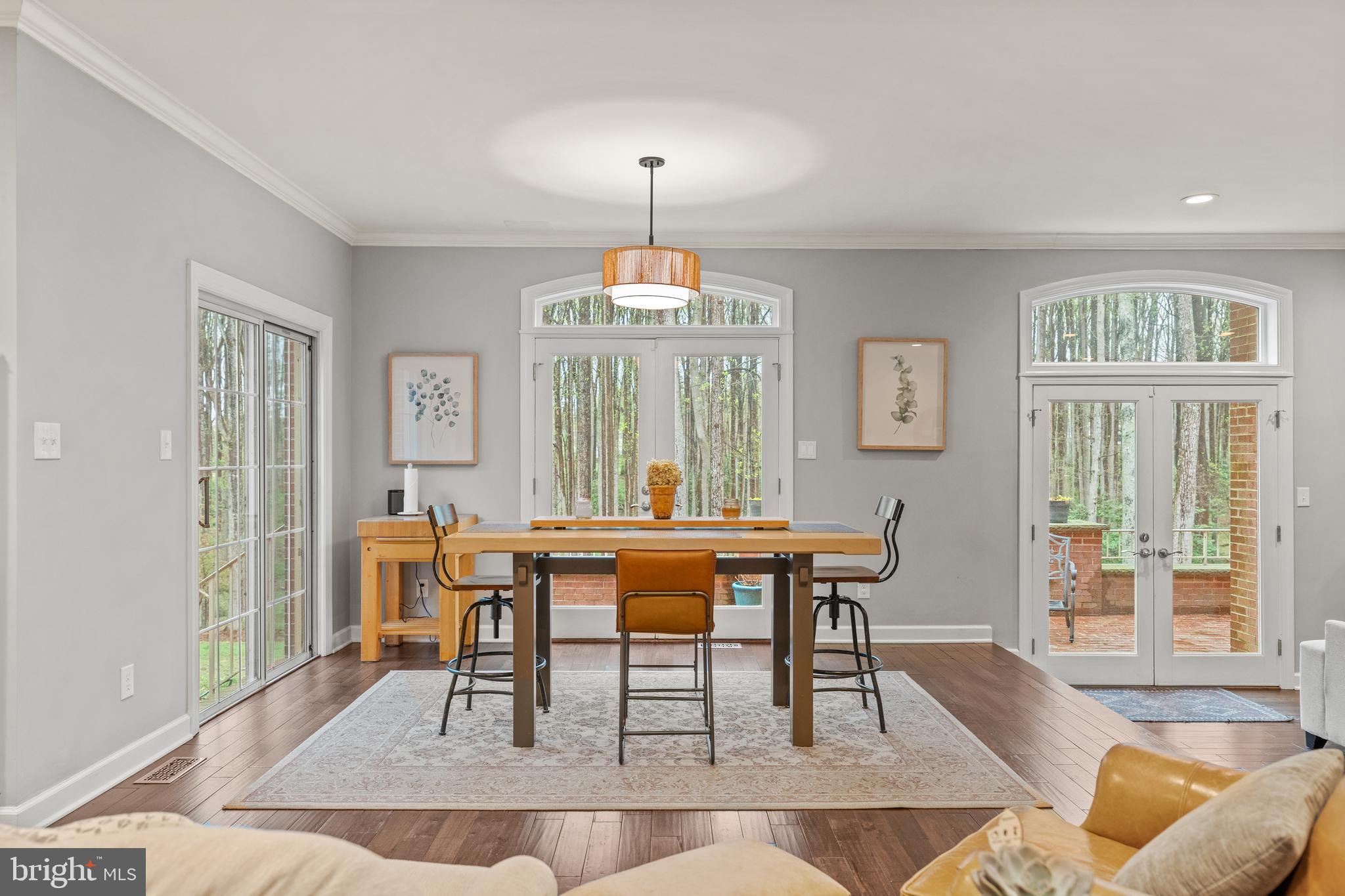 642 Springvale Road Great Falls, VA 22066 - Photo 8 of 50 a dining room with wooden floor and a chandelier