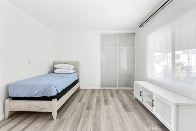 a bedroom with a bed and window