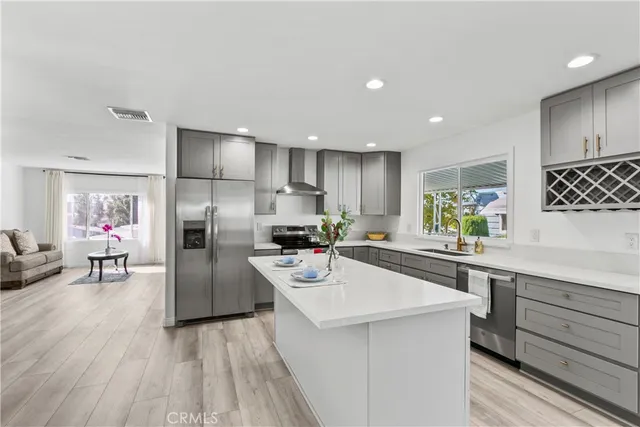 a kitchen with stainless steel appliances granite countertop a sink and cabinets