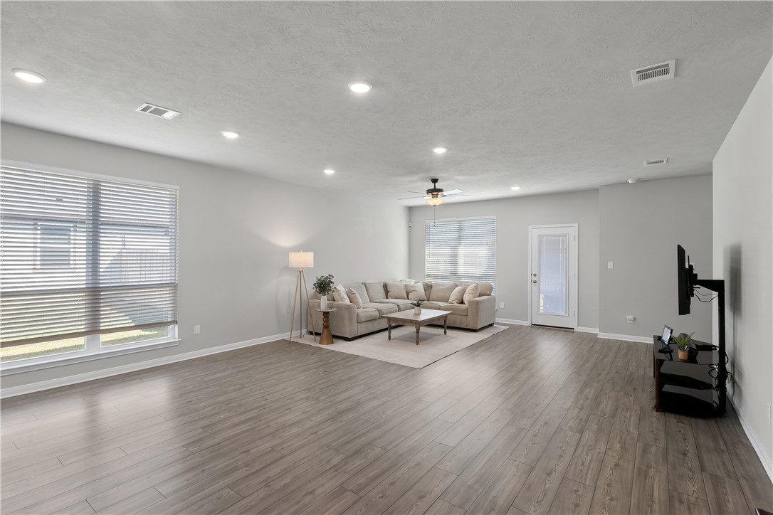 1925 Viva Road Bryan, TX 77807 - Photo 7 of 25 Living area with wood finished floors, a textured ceiling, recessed lighting, and ceiling fan