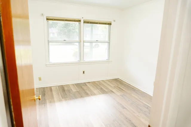 a view of a room with wooden floor
