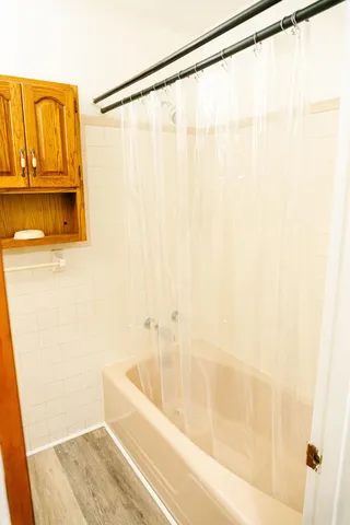 a bathroom with a bathtub and a shower