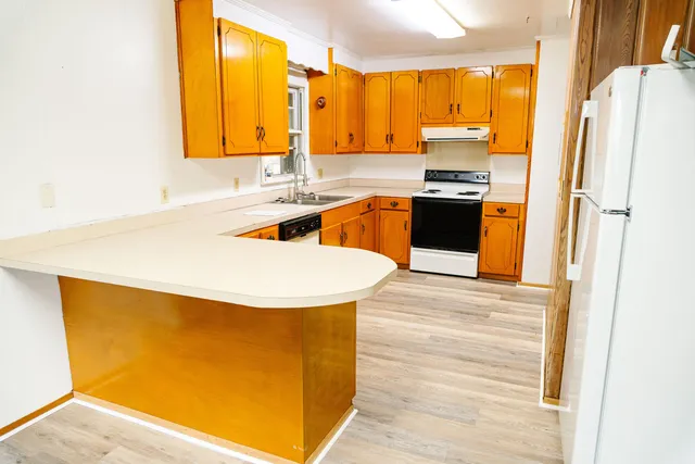 a view of an empty room with window and cabinet