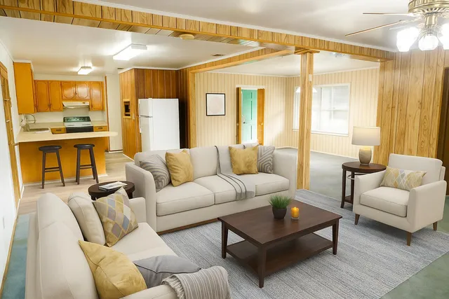 a view of a big room with wooden floor and a kitchen