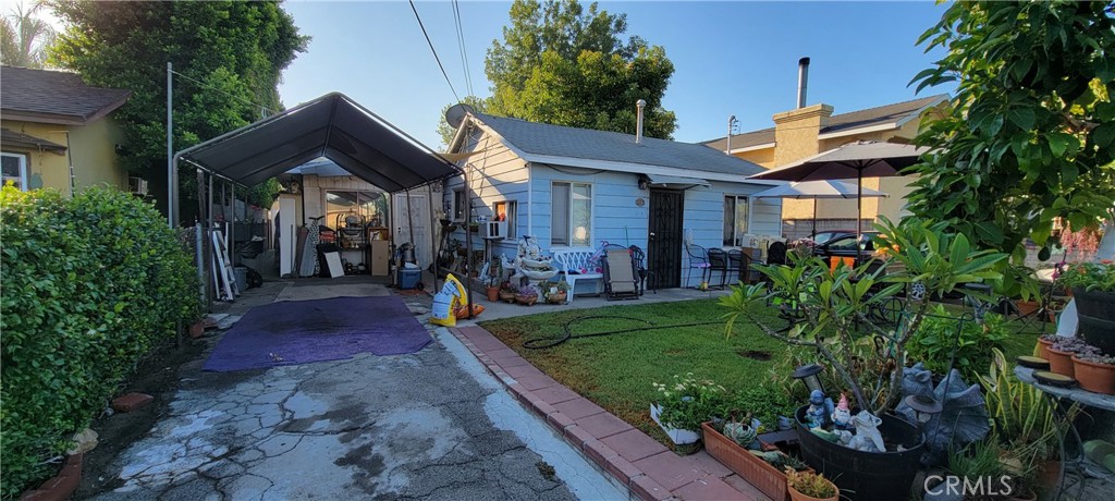 4014 Cedar Avenue El Monte, CA 91731 - Photo 2 of 5 a front view of a house with a yard and potted plants