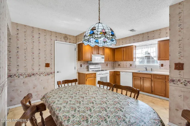 a kitchen with stainless steel appliances kitchen island granite countertop a sink and cabinets