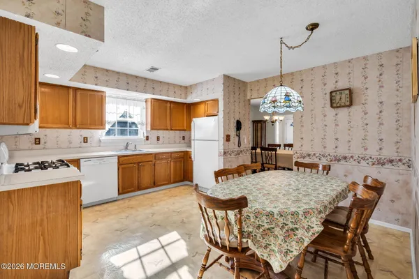 a kitchen with a table chairs stove and microwave
