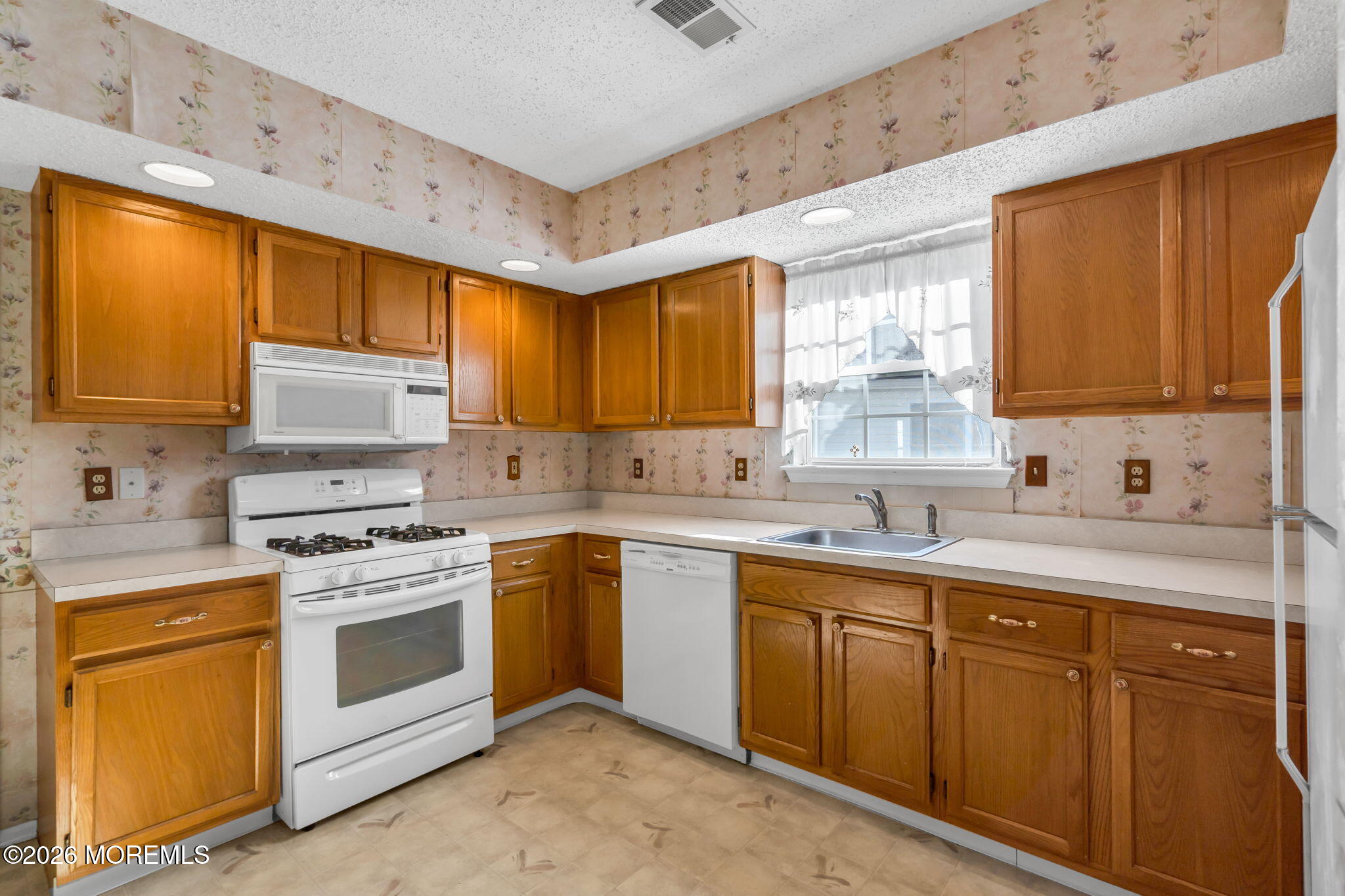 13 Golden Rod Court Brick, NJ 08724 - Photo 16 of 39 a kitchen with sink a stove and cabinets