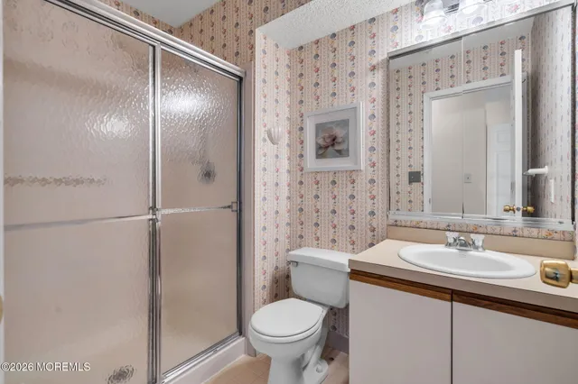 a bathroom with a toilet sink and shower