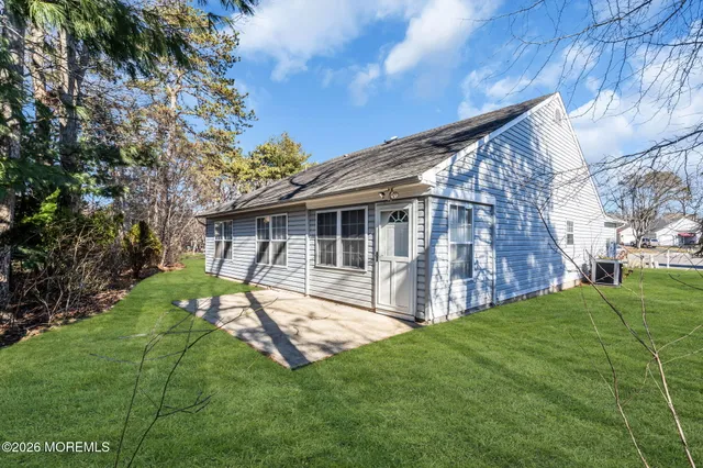 a view of backyard with table and chairs and potted plants