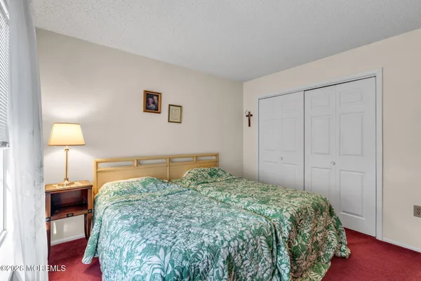 a bedroom with a bed and a lamp