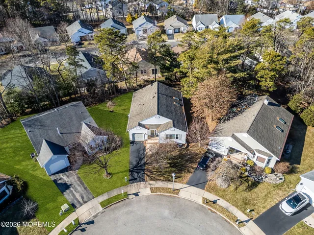 an aerial view of a house with a garden and trees