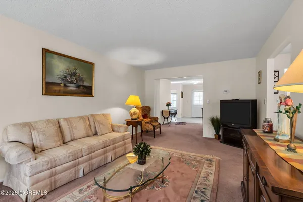 a living room with furniture and a flat screen tv with wooden floor