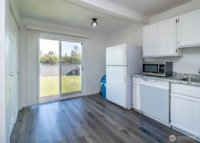 a kitchen with a wooden floor a sink and a stove